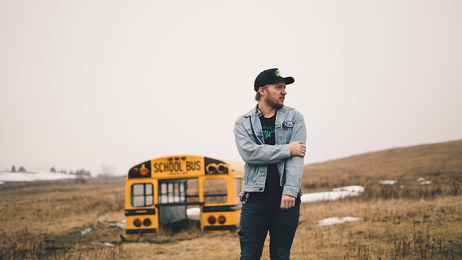 man standing near yellow school bus at daytime, guy, field HD wallpaper