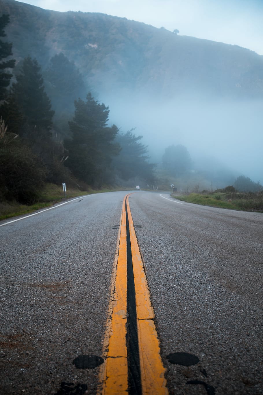 mountain covered with white fog, gray concrete road near mountain HD wallpaper