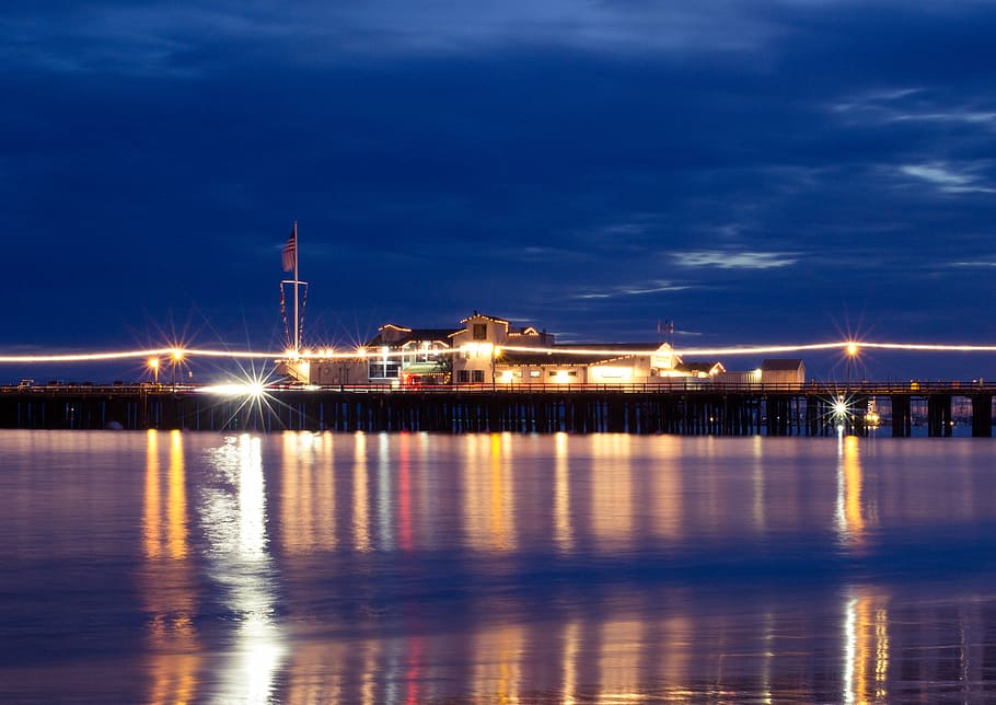 building, dock, lights, long-exposure, night, night time, ocean HD wallpaper