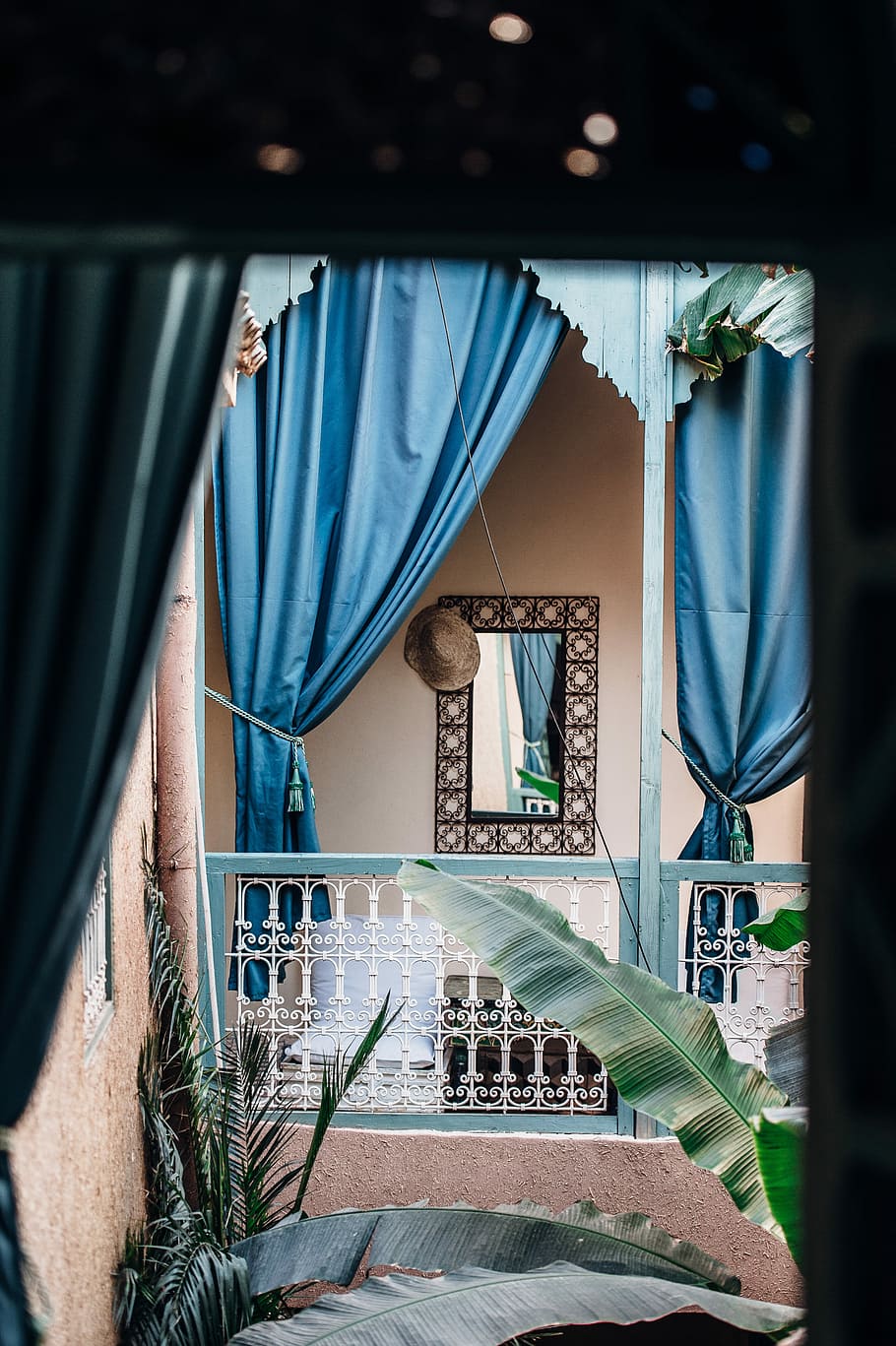 Riad Dar M’chicha, Marrakesh, two blue curtains, window, mirror