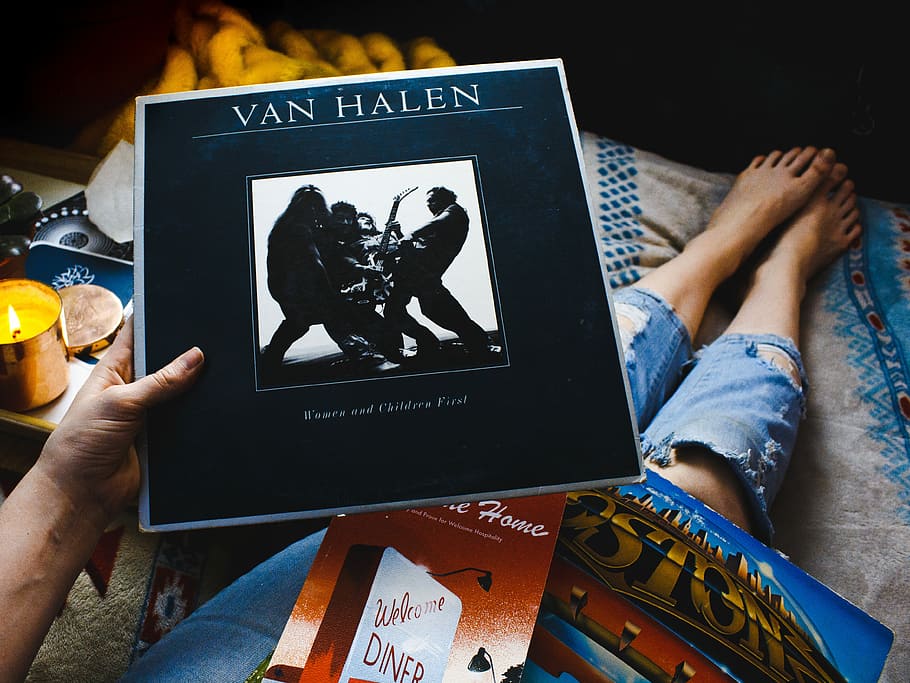 person holding Van Halen vinyl sleeve, person holding Van Halen album