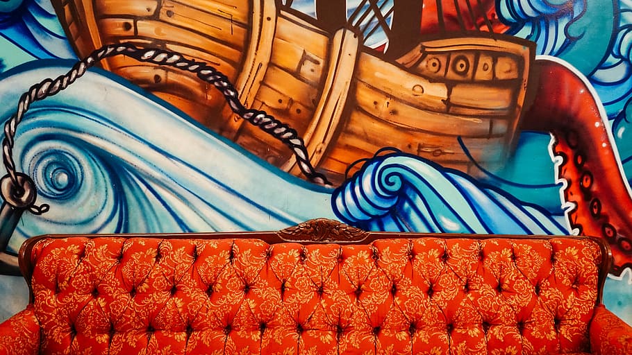 tufted orange sofa with brown boat mural paint in the back, brown chesterfield sofa on painted wall HD wallpaper