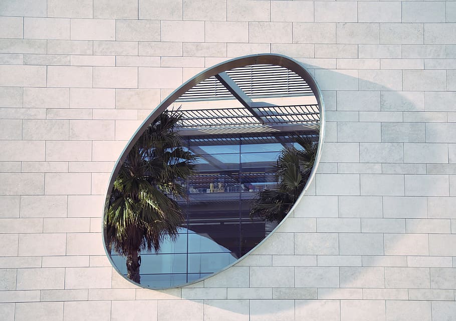 oval mirror on white brick pathway, photo of two green palm trees with oval frame HD wallpaper