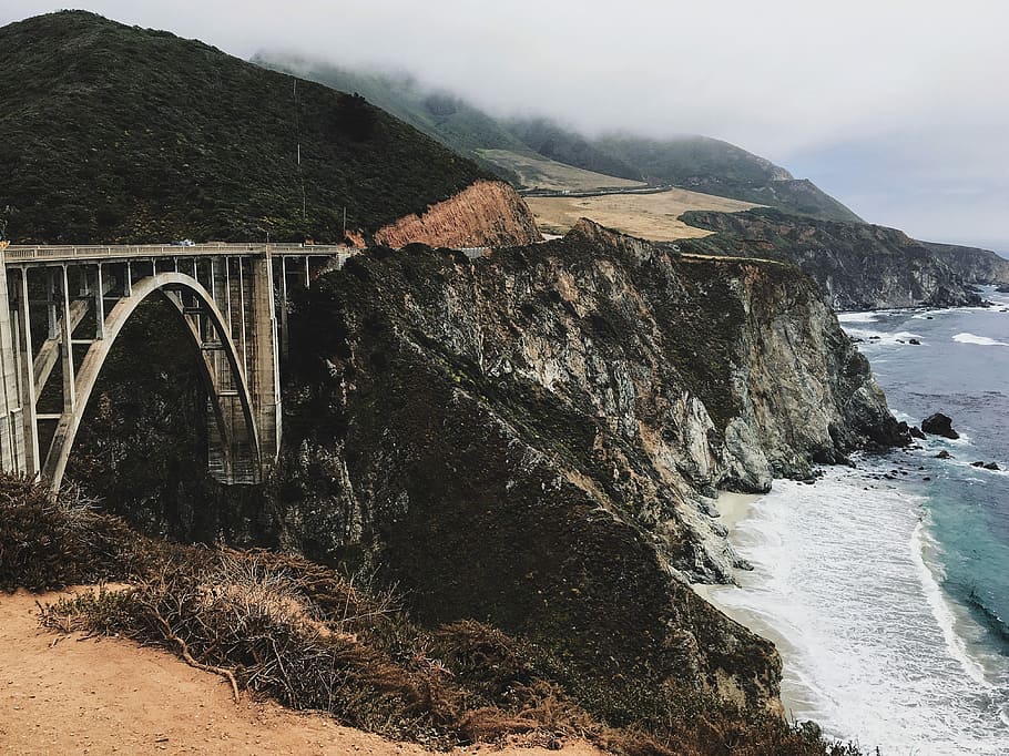 Big Sur, California, photo of bridge by the rock mountain by the sea HD wallpaper