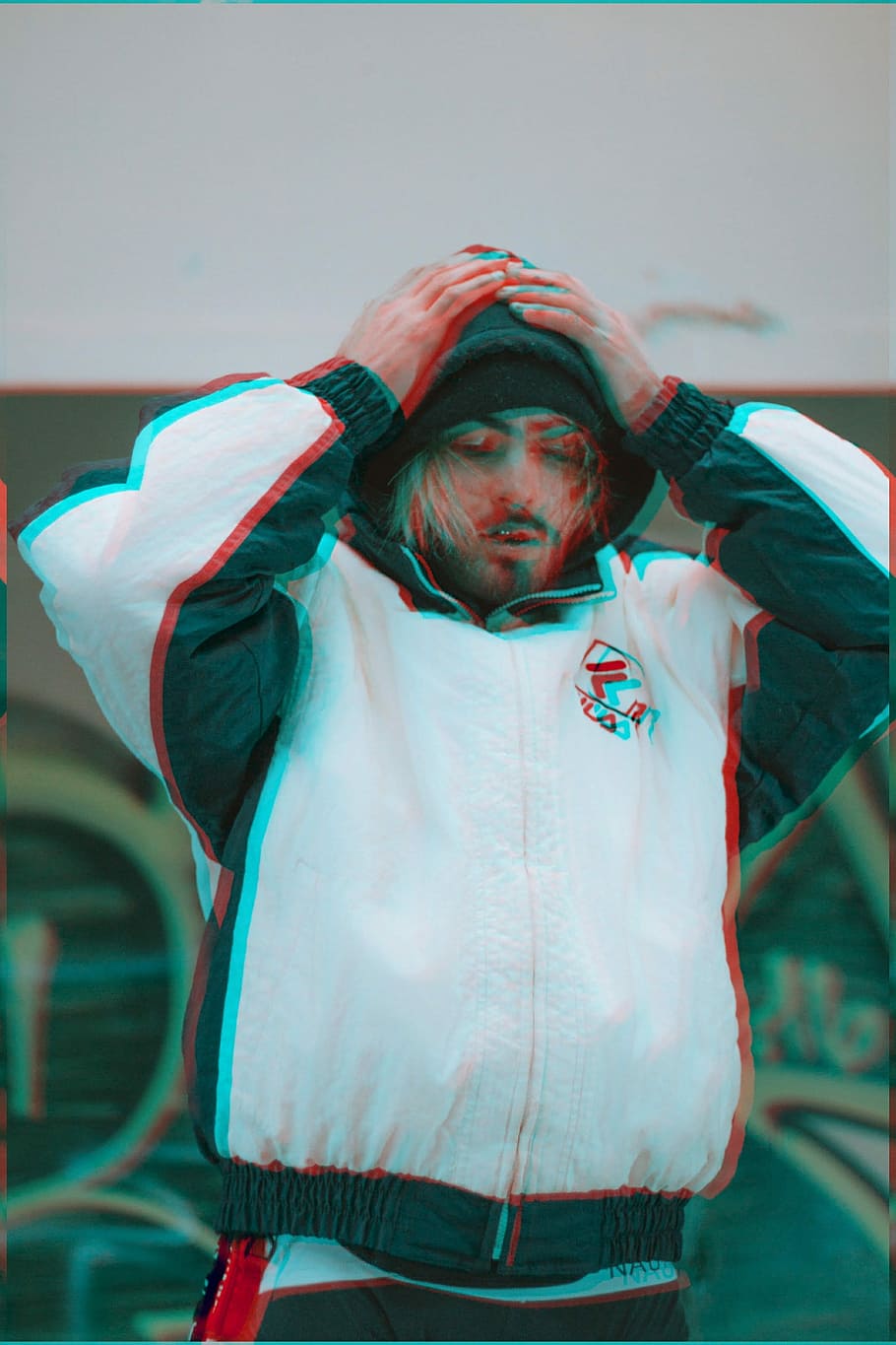 man holding his head, man in white and black FILA jacket holding head HD wallpaper