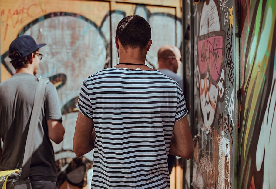 three men standing beside graffiti wall during daytime, people, HD wallpaper