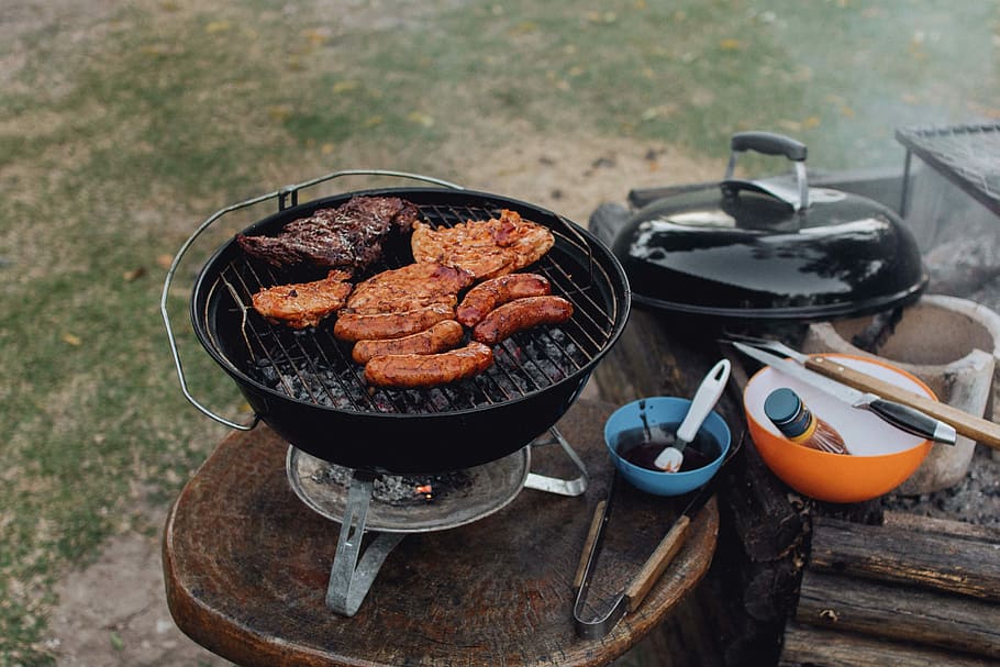 grilled meat and sausages on top of grill, meats and sausages grilled on round black charcoal grill on top of table HD wallpaper