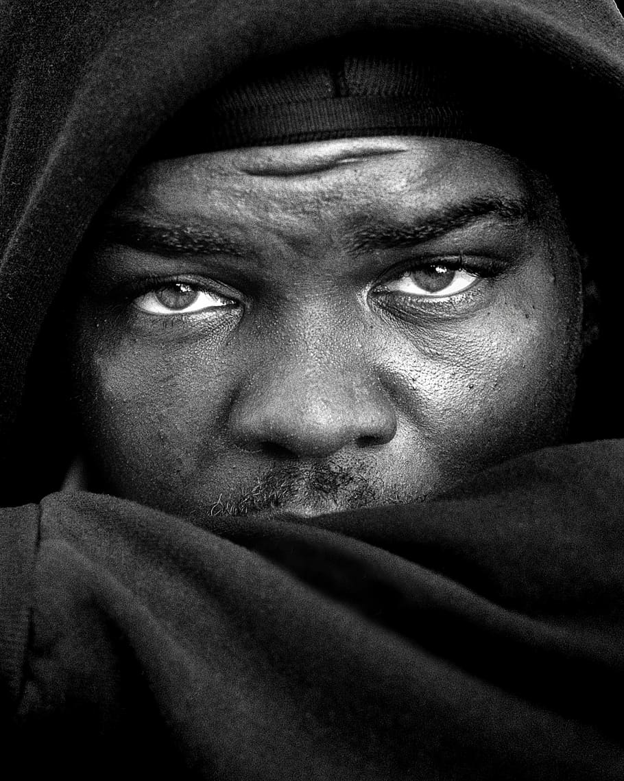 grayscale photo of man's face wearing hooded jacket, people, peoples