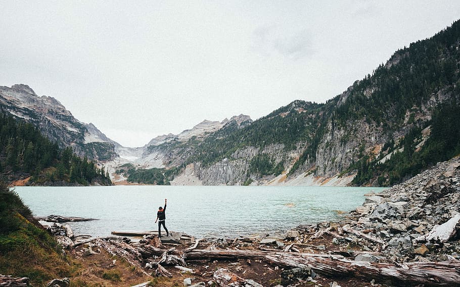man standing near water body during daytime, nature, mountain HD wallpaper