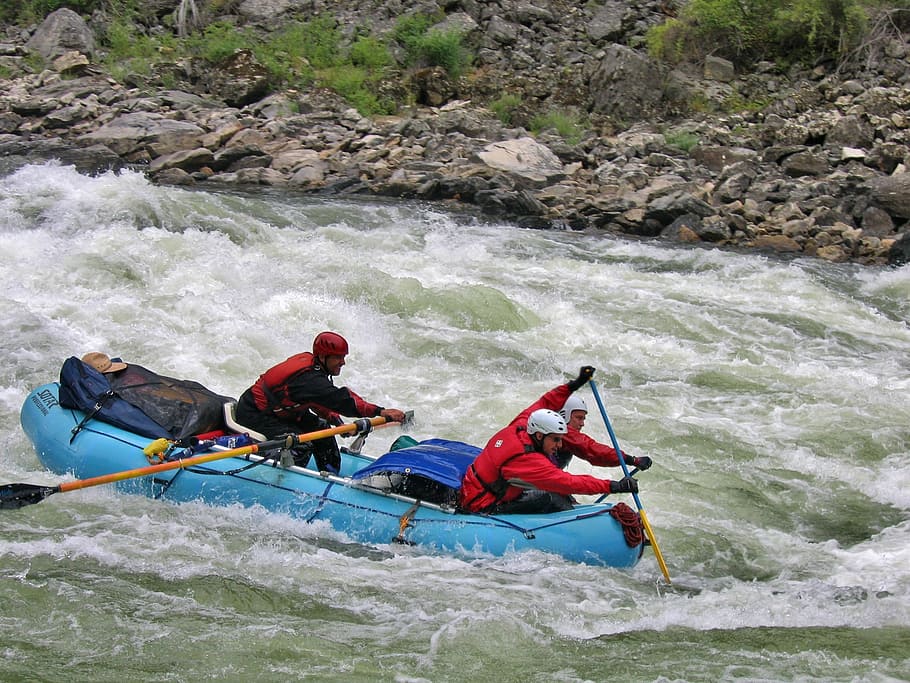 three man in red shirts on boat, rafting, rapids, paddle, team