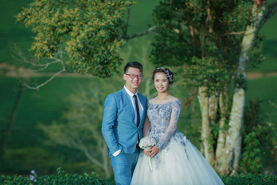 Vietnam wedding, smiling groom and bride standing in front of trees HD wallpaper
