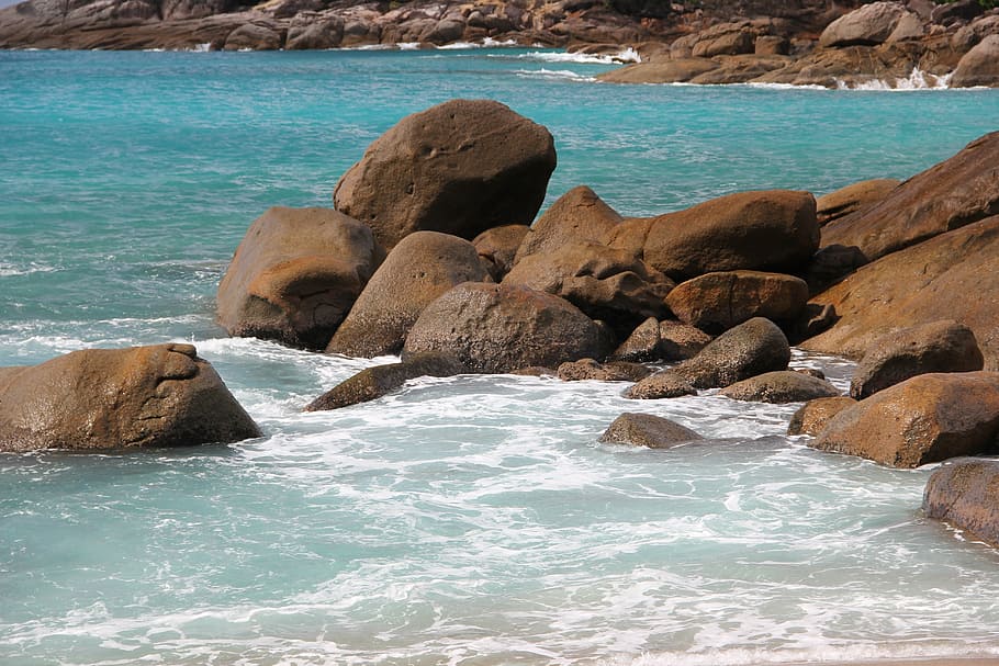 brown rocks by the shore during daytime, beach, seychelles, water