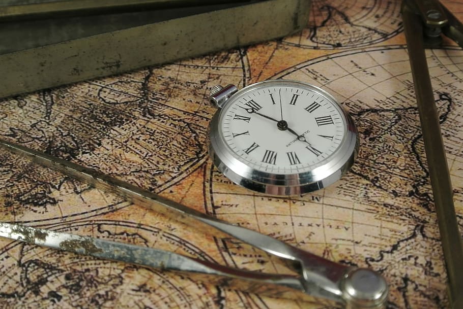 round silver analog watch on map surface, zirkel, lake map, time