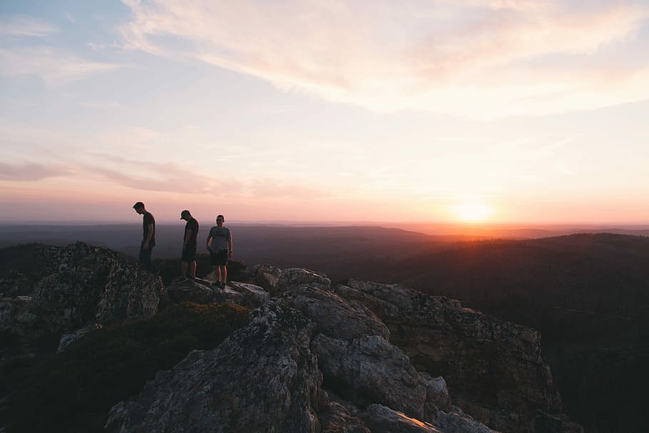 three person standing on mountain during daytime, three persons hiking on gray mountain HD wallpaper