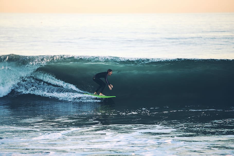 man surfing on sea at daytime, man riding green surfboard, wave HD wallpaper