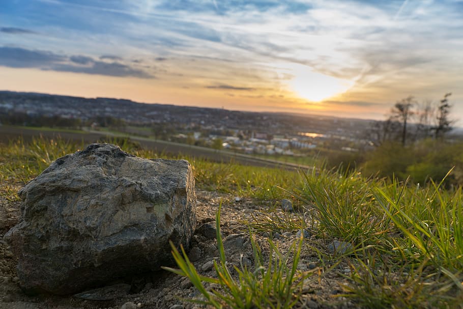 Gray Stone on Grassy Field during Under Cloudy Sky during Sunset HD wallpaper
