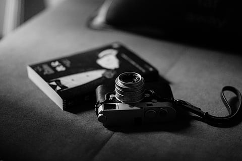 gray camera near book, grayscale photo of camera, table, minimal HD wallpaper