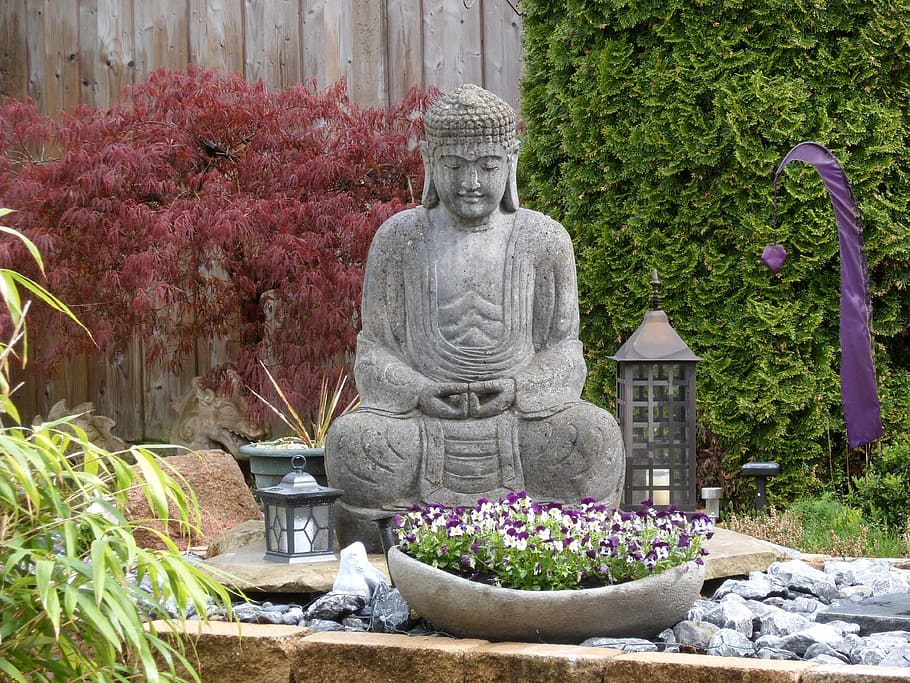 Gautama Buddha statue surrounded of plants, garden, sculpture