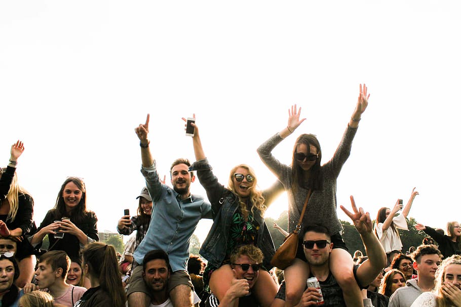 three men carrying women surrounded by many people during daytime, people at a party with beers raising their hands during daytime HD wallpaper