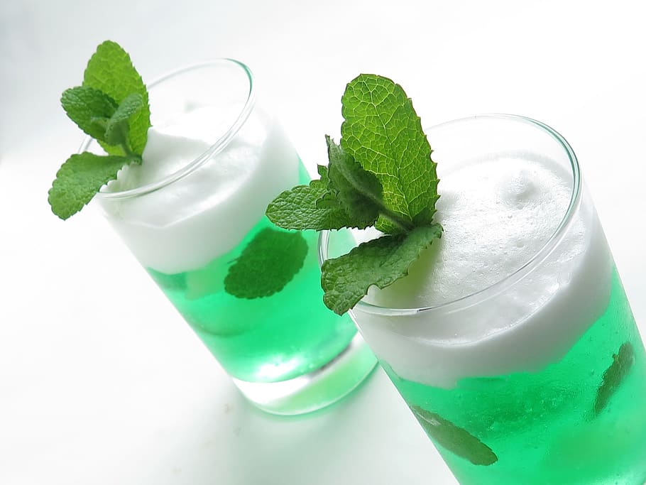 two green drinks in clear glass containers, suites, dessert, cake