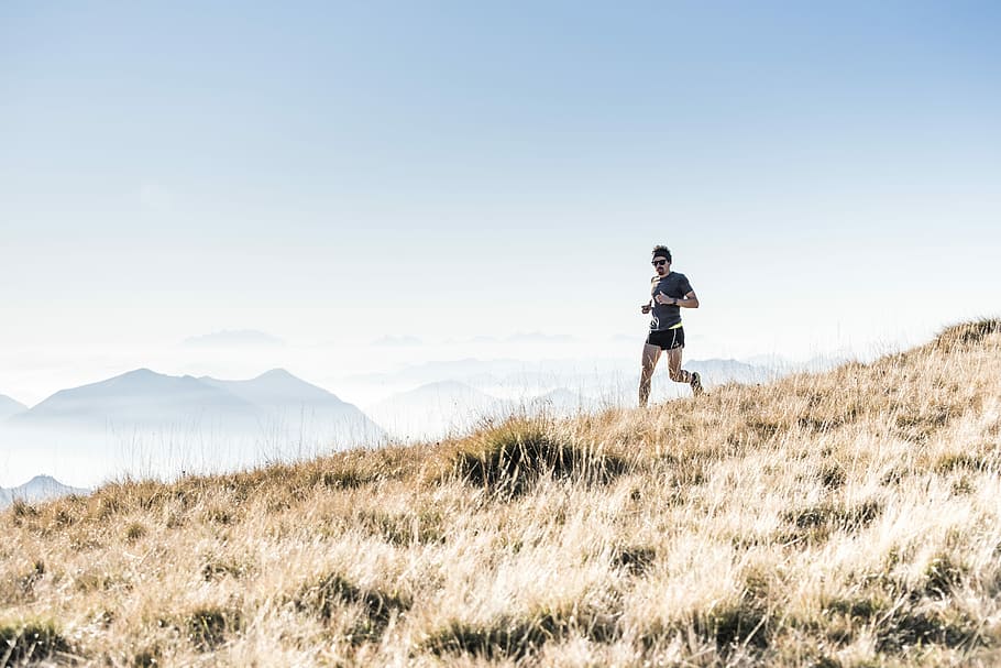 man running on the mountain, person running on grass during daytime, HD wallpaper