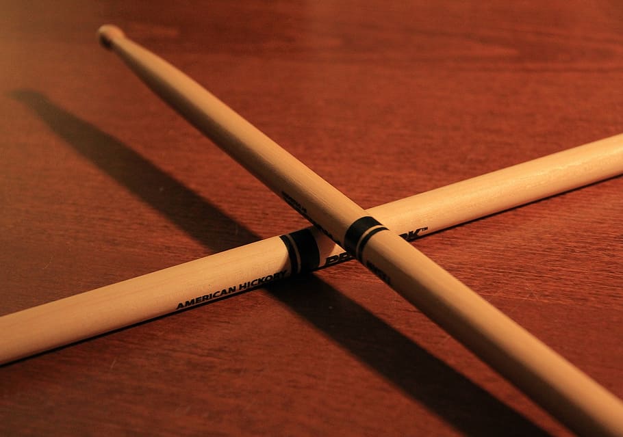 pair of brown drumsticks on wooden table, drum sticks, music