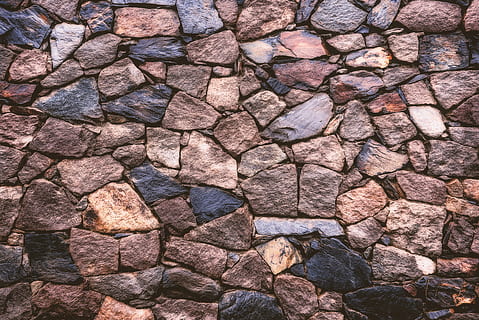 brown rock wall, person taking photo of assorted-color rocks HD wallpaper