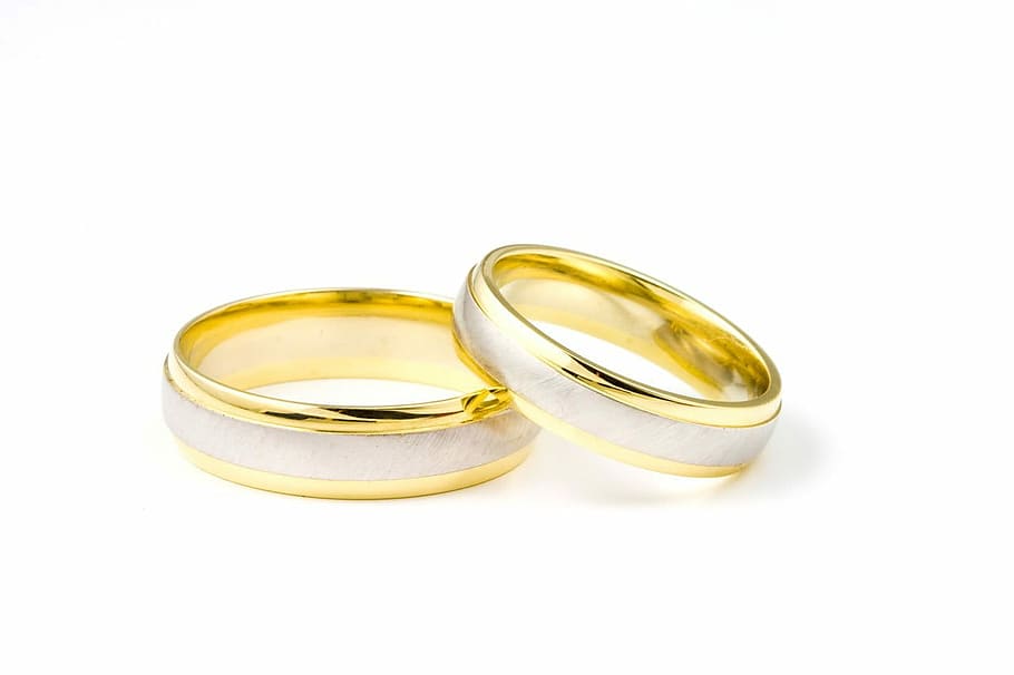 two silver-and-gold-colored bridal rings, pair, silver and gold