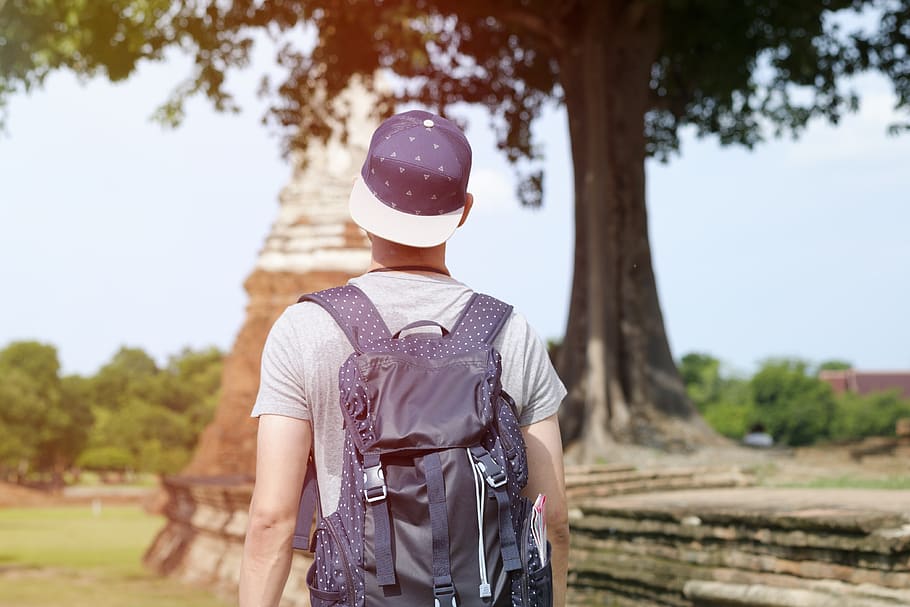 people, man, guy, cap, bag, backpack, walking, alone, reading HD wallpaper