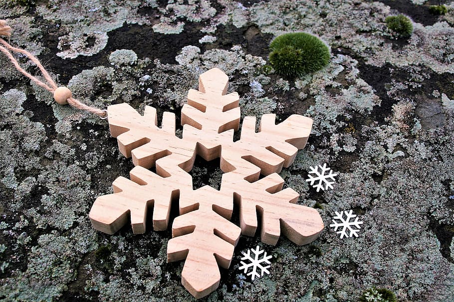 brown wooden snowflakes-themed hanging decor on gray surface