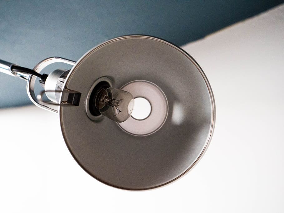 turned off white lamp with clear light bulb, gray desk lamp, closeup photography