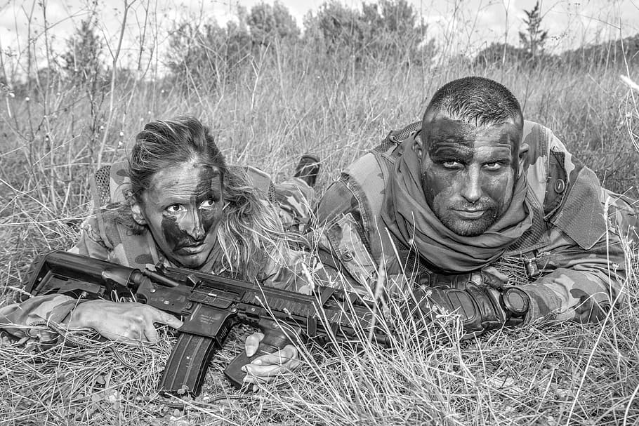 grayscale photo of two people prone lying on gass, uniform, army