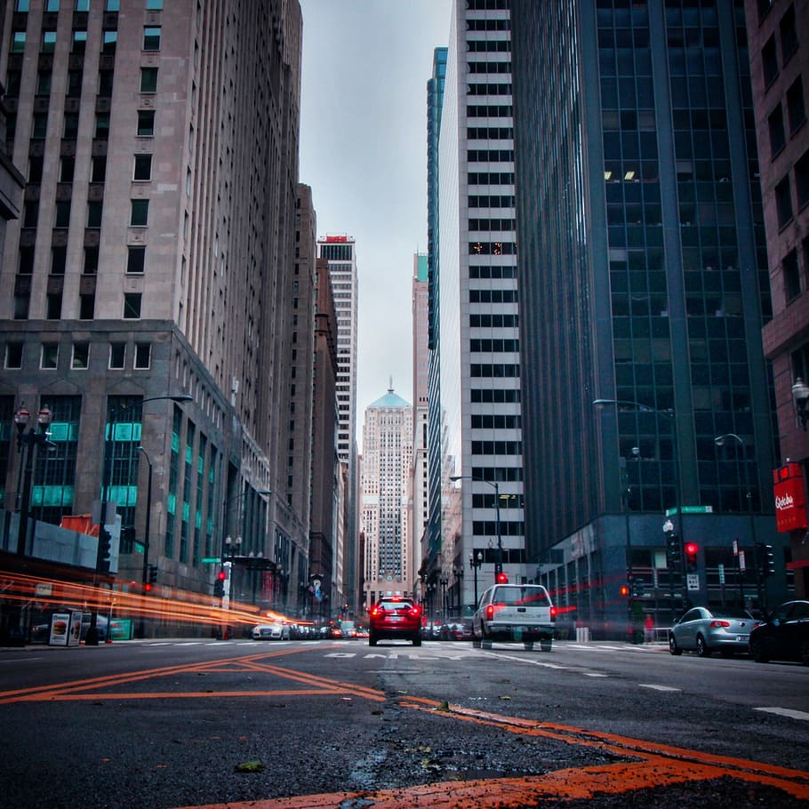 cars on road, red vehicle between high rise building, architecture HD wallpaper