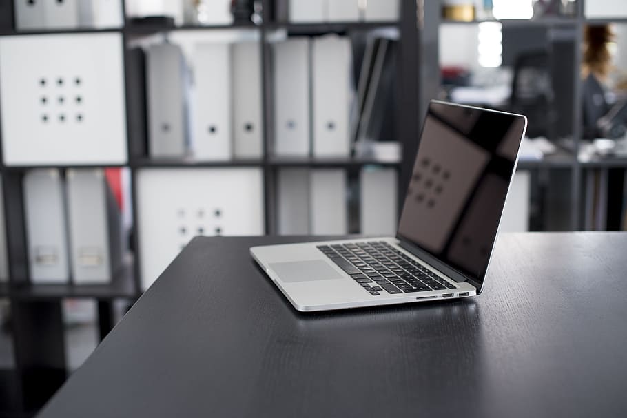 gray and black laptop on the black table in a well lit room HD wallpaper