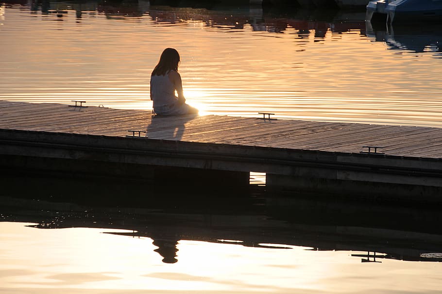 woman in white long-sleeved shirt sits on brown wooden dock, boat dock, HD wallpaper