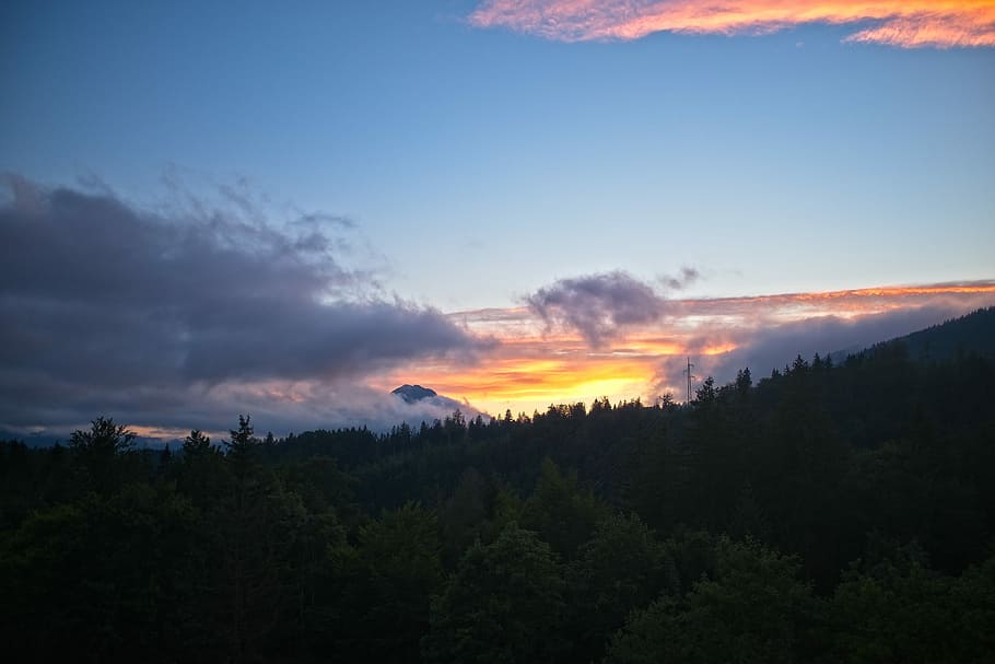 tree covered mountain taken under white clouds during golden hour, landscape photography of clouds and trees HD wallpaper