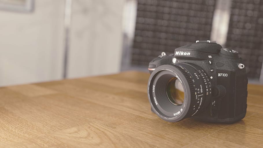 selective focus photography black Nikon DSLR camera on table HD wallpaper