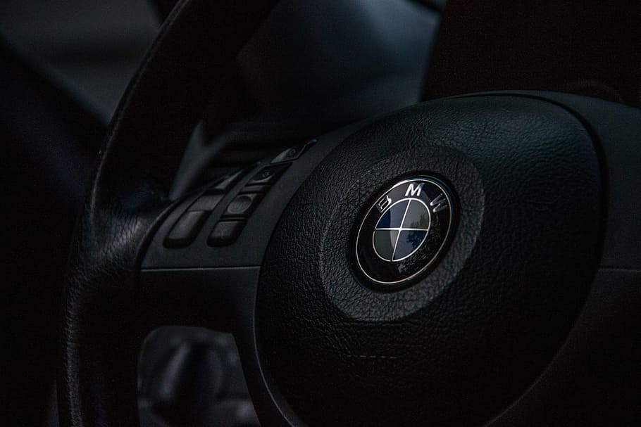 BMW emblem on steering wheel, motor car, driver, automobile, interior