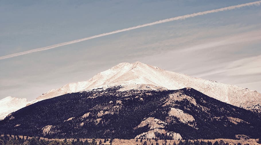 landscape photography of black and white mountains, trees near mountain under cloudy sky HD wallpaper