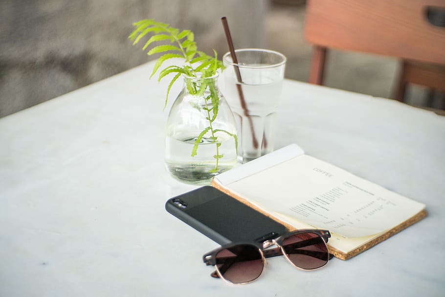 black framed sunglasses beside black cased smartphone and white covered book on white table, black Clubmaster-framed sunglasses beside book on white tablecloth, HD wallpaper