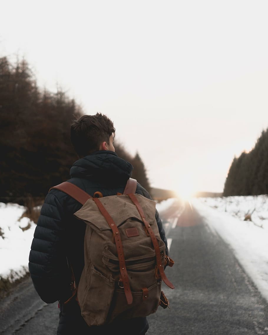 man wearing brown backpack standing on gray road at daytime, snow, HD wallpaper