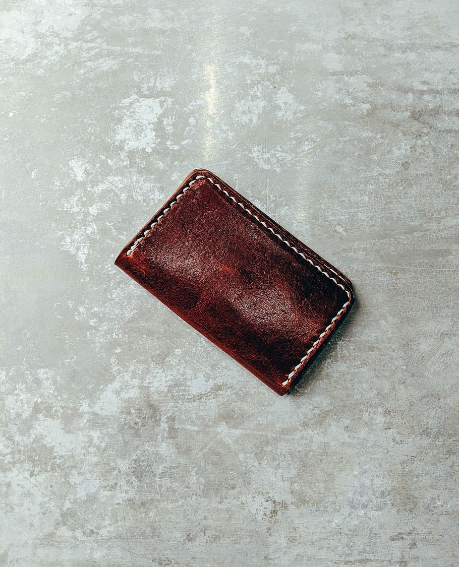 closed brown leather wallet on concrete, brown leather bifold wallet, HD wallpaper
