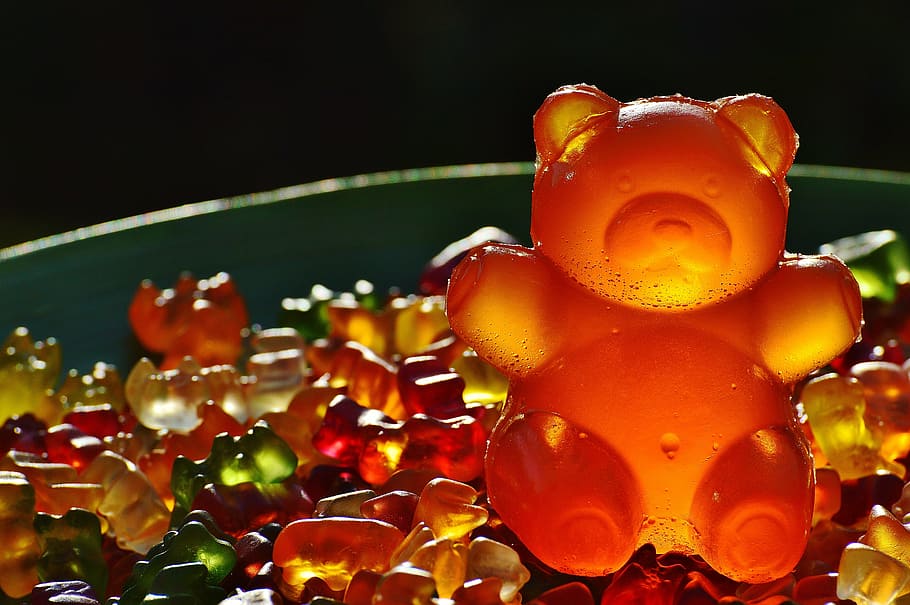 orange gummy bear candy on top of pile of smaller gummy bears, HD wallpaper