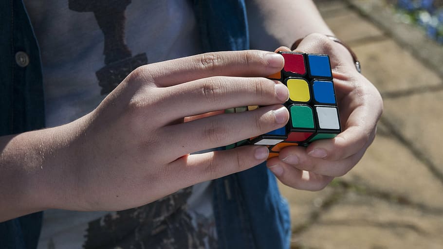 person holding Rubik's cube, hand, boy, young, youth, fingers HD wallpaper