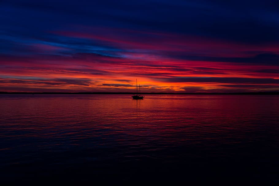 boat on sea under red and blue sky, lone, light, sunset, dusk