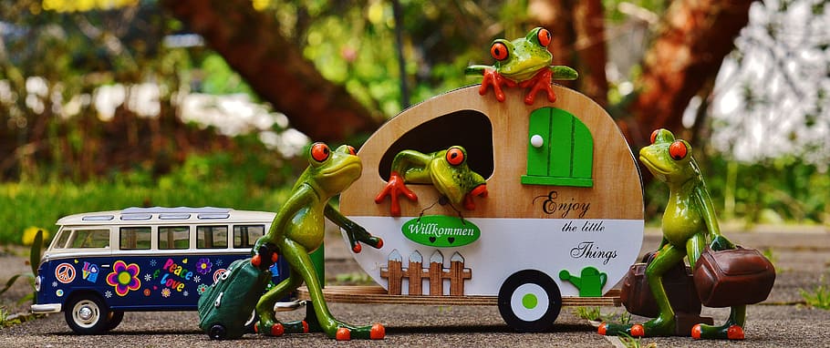 green ceramic frog figurines and brown trailer miniature, frogs
