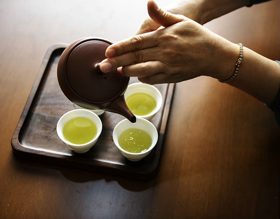 person filling cups with green liquid beverage, drink, tea HD wallpaper