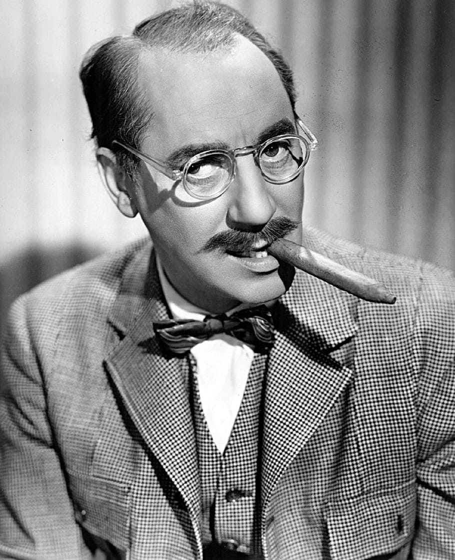 grayscale photo of man with tobacco and eyeglasses, groucho marx
