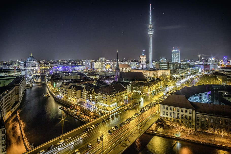 time-lapse photography of vehicle at the road in between the building at nighttime aerial photography, aerial photography of city during night time HD wallpaper