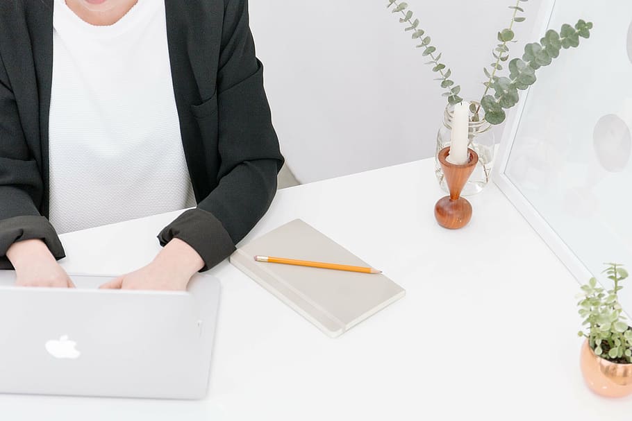 person using MacBook Pro on table, woman, front, working, typing HD wallpaper